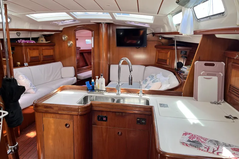 Slide: The Image of Interior of 2001 Beneteau 473 yacht with cozy seating and modern kitchen amenities. - 29