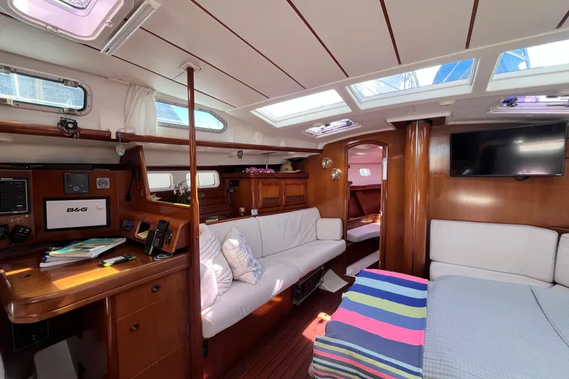 Slide: The Image of Interior of 2001 Beneteau 473 yacht with cozy seating and navigation station. - 3