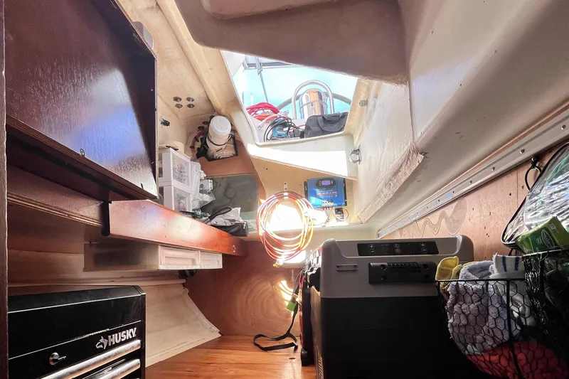 Slide: The Image of Interior of a 2001 Beneteau 473 sailboat, featuring storage and equipment. - 38