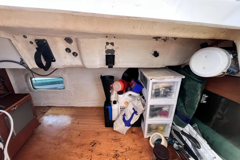 Slide: The Image of Interior storage area of a 2001 Beneteau 473 sailboat with various supplies and tools. - 39