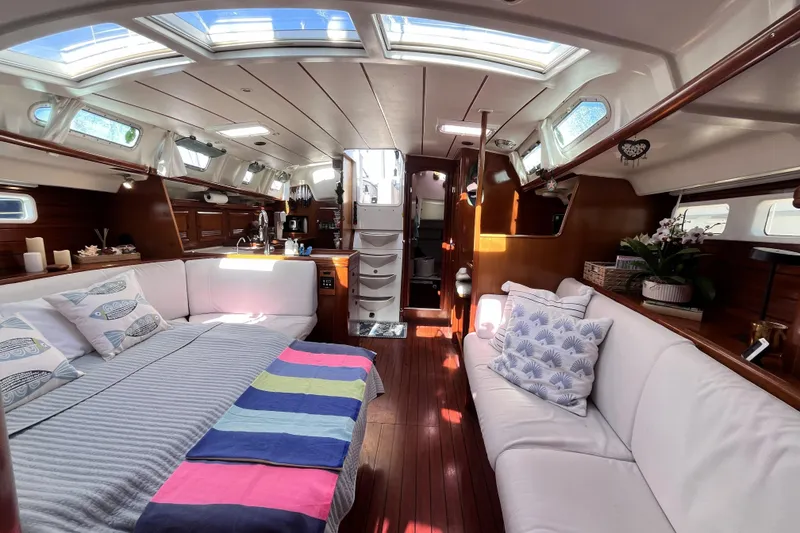 Slide: The Image of Luxurious interior of a 2001 Beneteau 473 yacht with elegant wood finishes and cozy seating. - 4