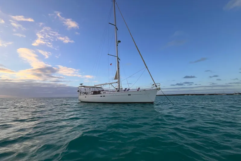 Slide: The Image of Sailing yacht Beneteau 473, 2001 model, anchored on calm ocean at sunset. - 45