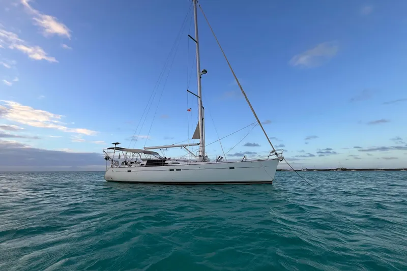 Slide: The Image of Sailing yacht Beneteau 473, 2001 model, anchored on calm ocean waters under a clear sky. - 46