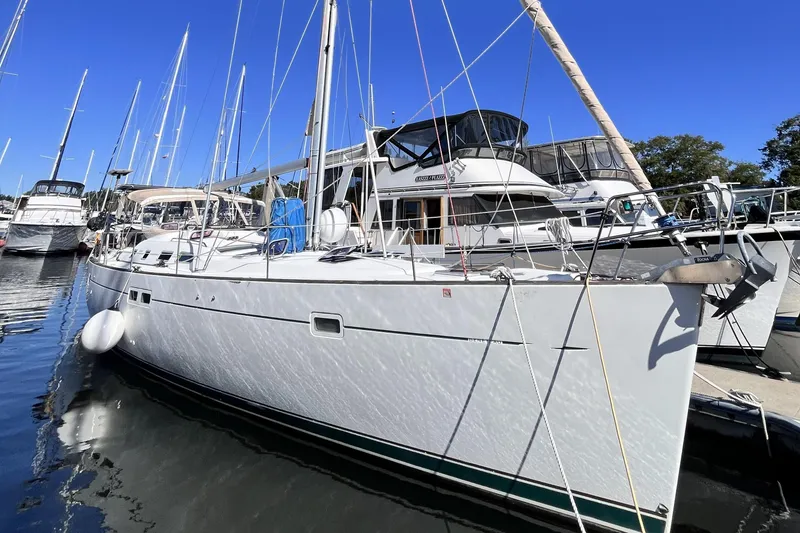 Slide: The Image of 2001 Beneteau 473 sailboat docked in a marina under clear blue skies. - 47