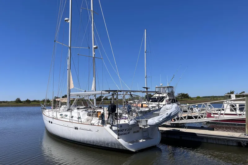 Slide: The Image of Sailboat Beneteau 473, 2001 model, docked at a marina under clear blue skies. - 49