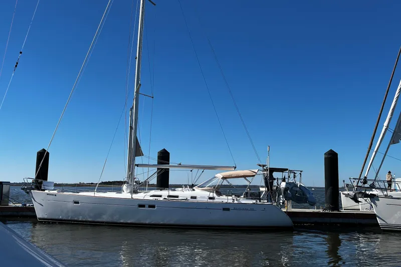 Slide: The Image of 2001 Beneteau 473 sailboat docked on a sunny day with clear blue skies. - 50