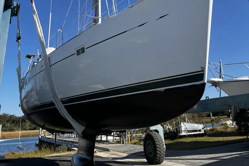 Slide: The Image of 2001 Beneteau 473 sailboat on a lift, showcasing hull and keel design. - 52
