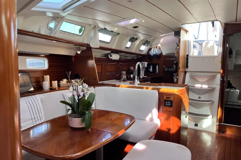Slide: The Image of Luxurious interior of a 2001 Beneteau 473 yacht with elegant wood finishes and modern amenities. - 7