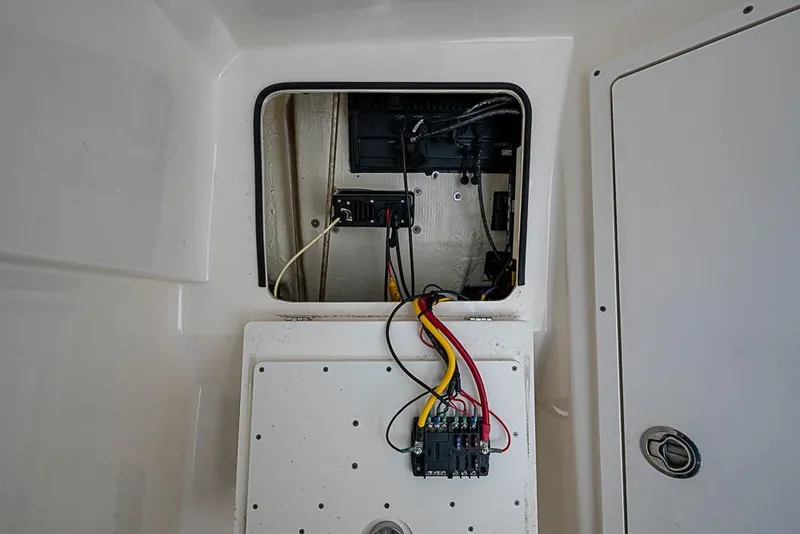 Slide: The Image of Electrical panel inside a 2021 Cobia 320 Center Console boat, showing wiring and components. - 17
