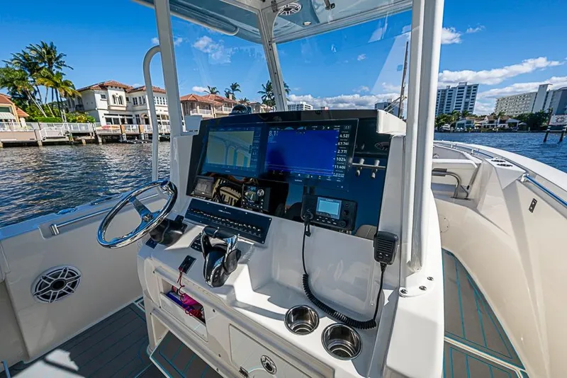 Slide: The Image of 2021 Cobia 320 Center Console boat dashboard with navigation screens and controls. - 18