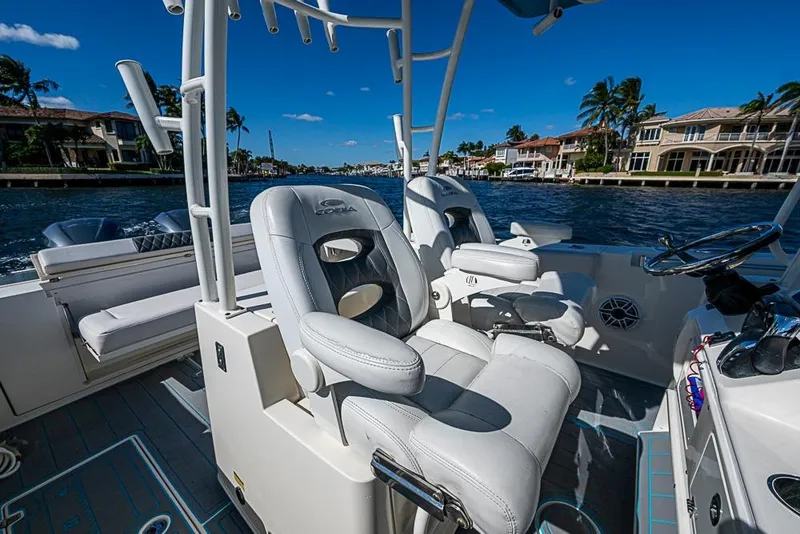 Slide: The Image of 2021 Cobia 320 Center Console boat interior with luxurious seating and waterfront view. - 22
