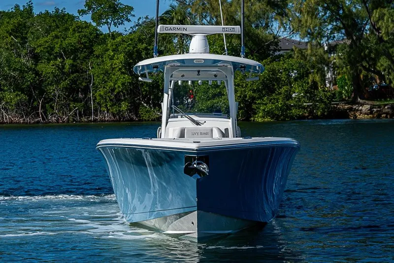 Slide: The Image of 2021 Cobia 320 Center Console boat cruising on a scenic waterway. - 35