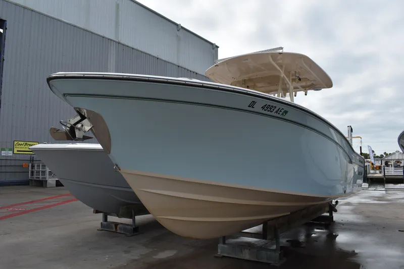 The Image of 2012 Grady-White Canyon 271 boat with Yamaha engine on dock under blue sky. - 0