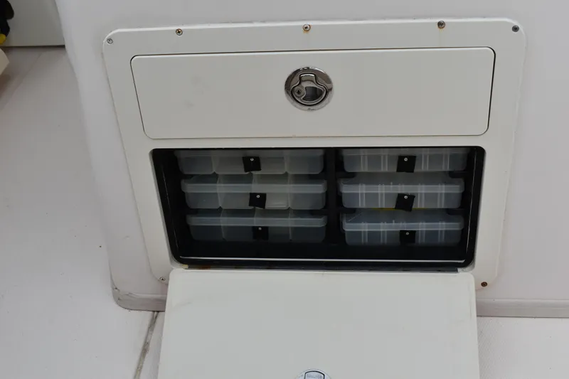 Slide: The Image of 2012 Grady-White Canyon 271 boat interior with rod storage and cushioned seating. - 16