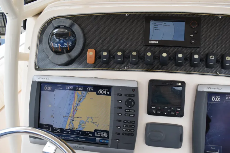 Slide: The Image of 2012 Grady-White Canyon 271 boat interior with rod holders and storage compartments. - 18