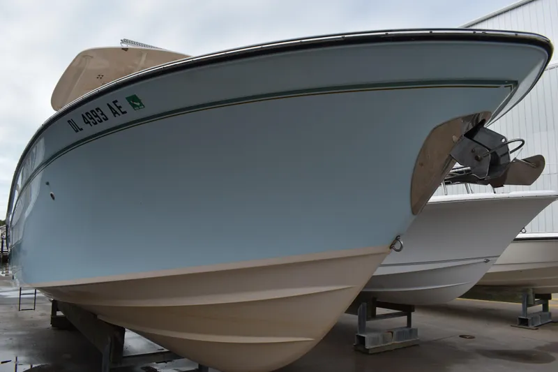 Slide: The Image of 2012 Grady-White Canyon 271 boat docked with Yamaha engine, clear sky background. - 2