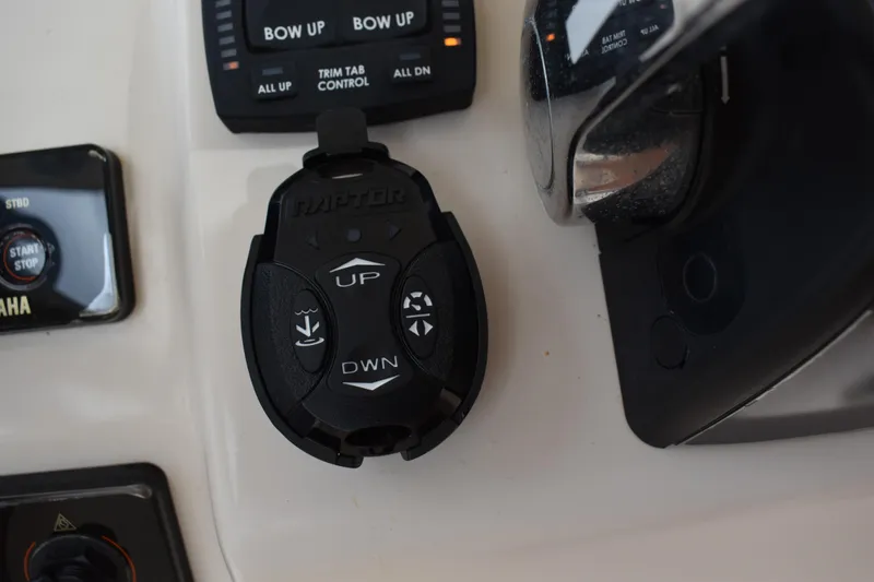 Slide: The Image of 2012 Grady-White Canyon 271 boat interior with cushioned seating and dual Yamaha 300 engines. - 23