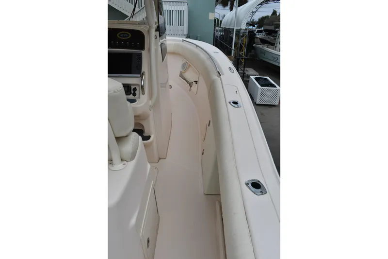 Slide: The Image of 2012 Grady-White Canyon 271 boat dashboard with clear windshield and water view. - 27