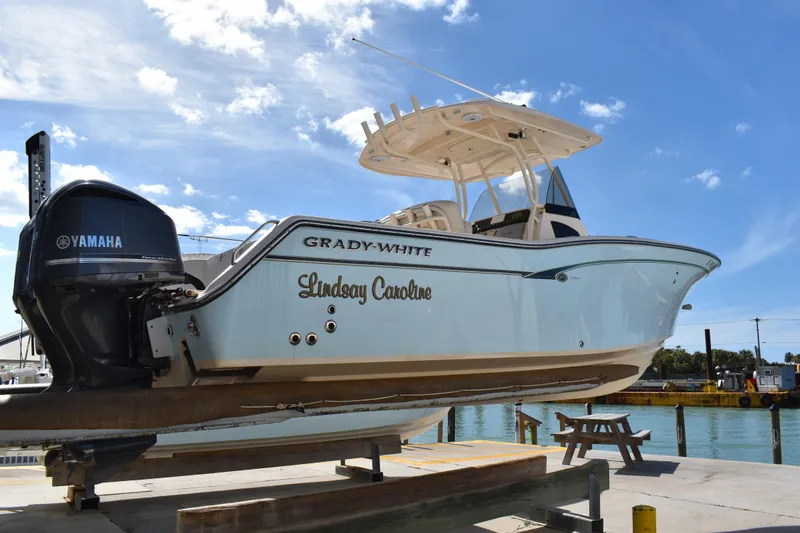 Slide: The Image of 2012 Grady-White Canyon 271 boat interior with cushioned seating and cup holders. - 42