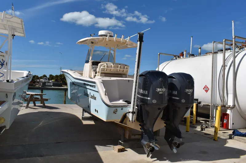 Slide: The Image of 2012 Grady-White Canyon 271 boat with Garmin radar, docked near waterfront buildings. - 45