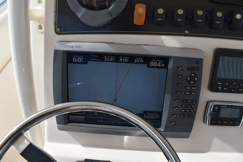 Slide: The Image of 2012 Grady-White Canyon 271 boat docked beside another vessel. - 51