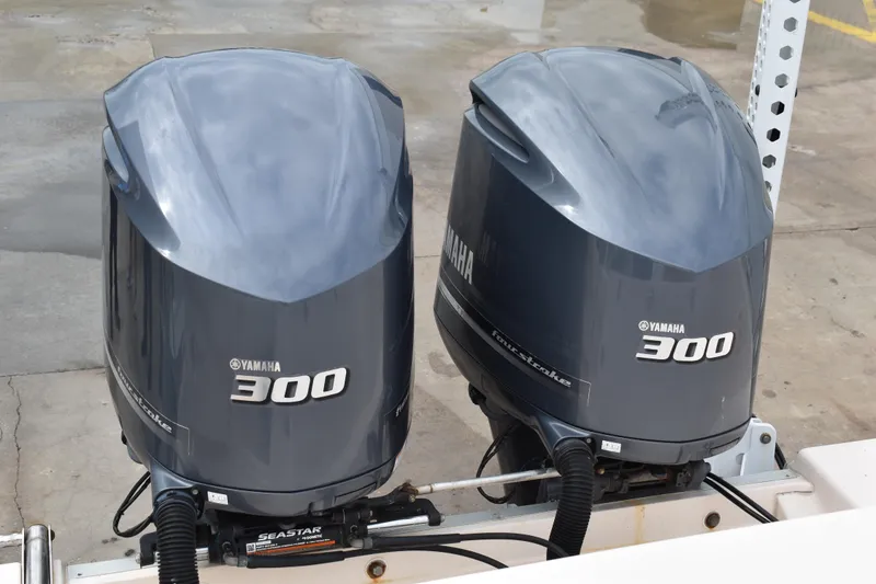 Slide: The Image of 2012 Grady-White Canyon 271 boat storage area with cleaning tools and speaker. - 9