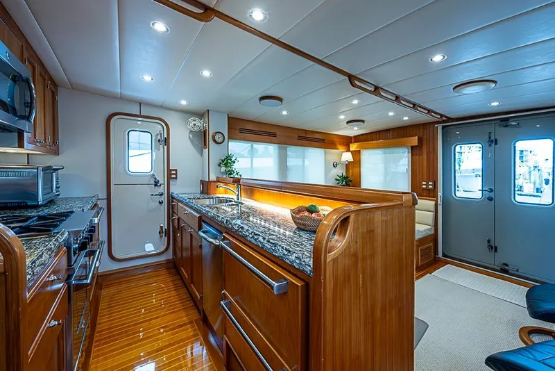 Slide: The Image of Luxurious interior of 2016 Kadey-Krogen 52 yacht with modern kitchen and elegant wood finishes. - 11