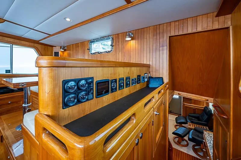 Slide: The Image of Interior of 2016 Kadey-Krogen 52 yacht with wooden paneling and control instruments. - 16