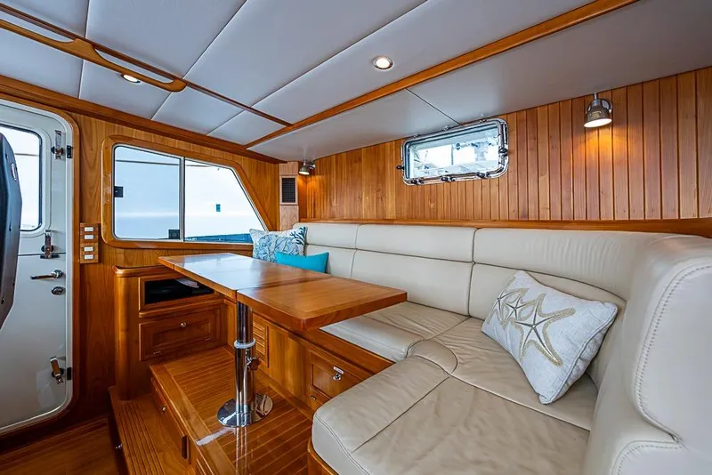 Slide: The Image of Luxurious interior of 2016 Kadey-Krogen 52 yacht with wood paneling and plush seating. - 17