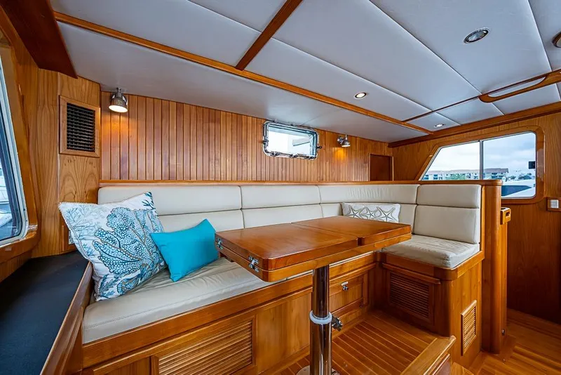 Slide: The Image of Luxurious 2016 Kadey-Krogen 52 yacht interior with elegant wood paneling and cozy seating area. - 18