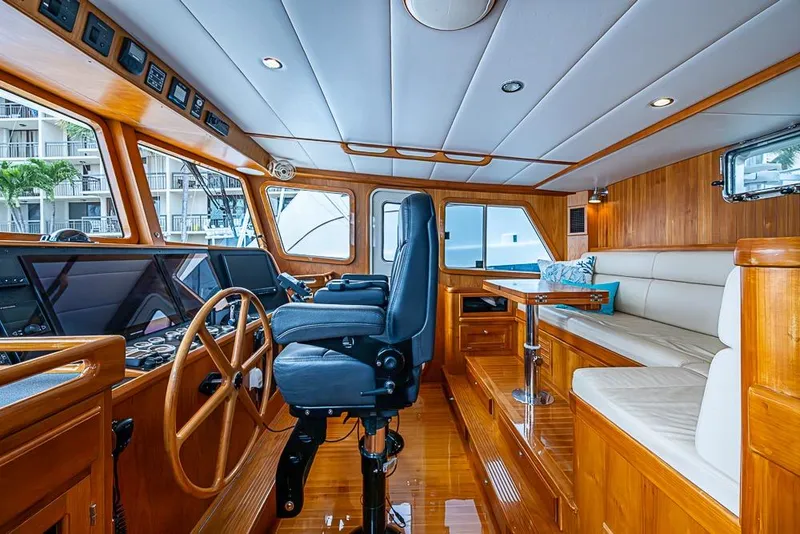 Slide: The Image of Luxurious 2016 Kadey-Krogen 52 yacht interior with helm, seating, and wooden finishes. - 19