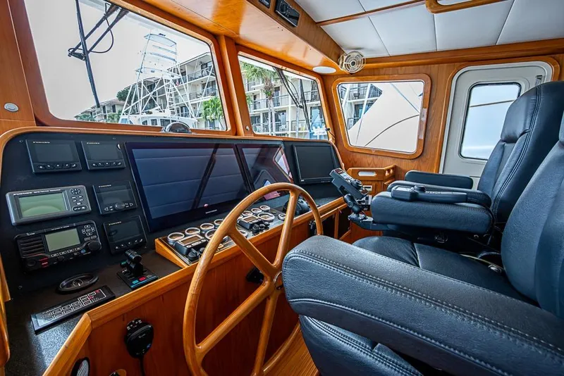 Slide: The Image of Pilothouse of 2016 Kadey-Krogen 52 yacht with navigation equipment and leather seating. - 20
