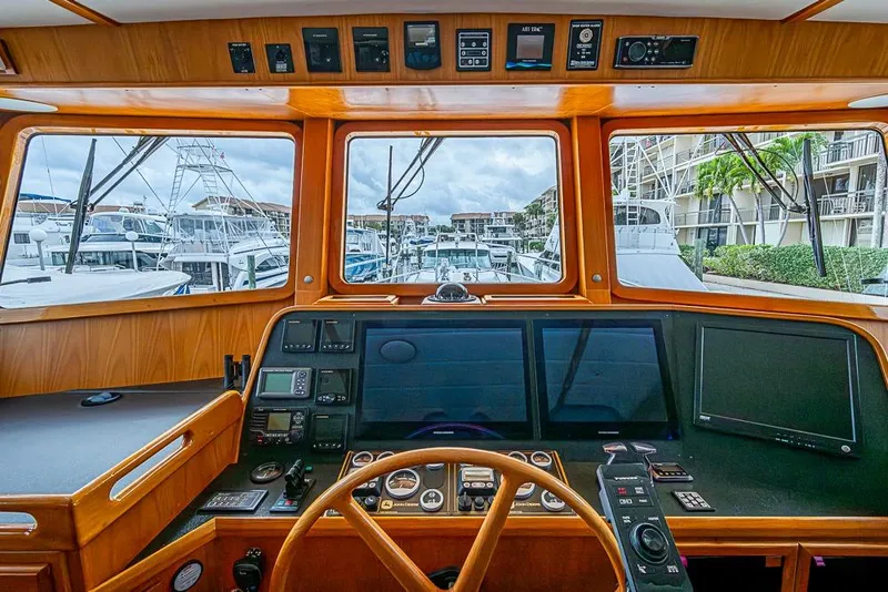 Slide: The Image of Pilothouse of 2016 Kadey-Krogen 52 yacht with navigation equipment and marina view. - 21