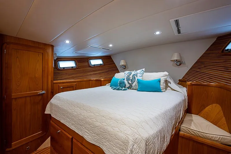 Slide: The Image of Luxurious 2016 Kadey-Krogen 52 yacht bedroom with elegant wood finish and cozy bedding. - 26