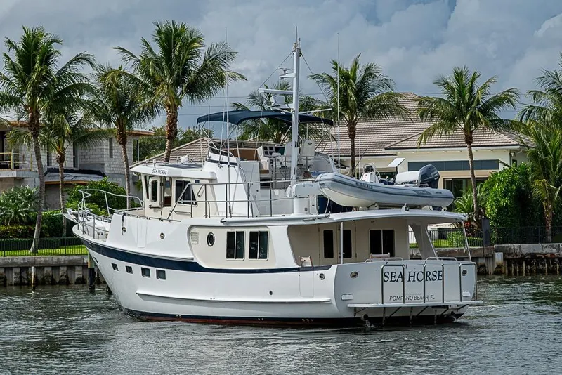 Slide: The Image of 2016 Kadey-Krogen 52 yacht "Sea Horse" docked near palm trees and waterfront homes. - 3