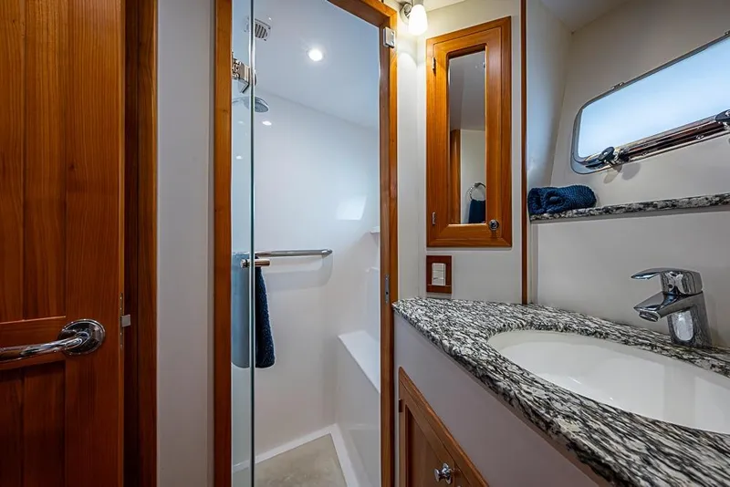 Slide: The Image of Luxurious bathroom in 2016 Kadey-Krogen 52 yacht with granite countertop and glass shower. - 30