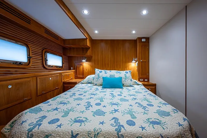 Slide: The Image of Luxurious 2016 Kadey-Krogen 52 yacht bedroom with nautical-themed bedding and wooden interior. - 33