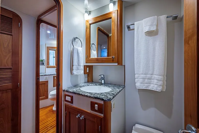 Slide: The Image of Luxurious bathroom in 2016 Kadey-Krogen 52 yacht with wooden cabinetry and granite countertop. - 36