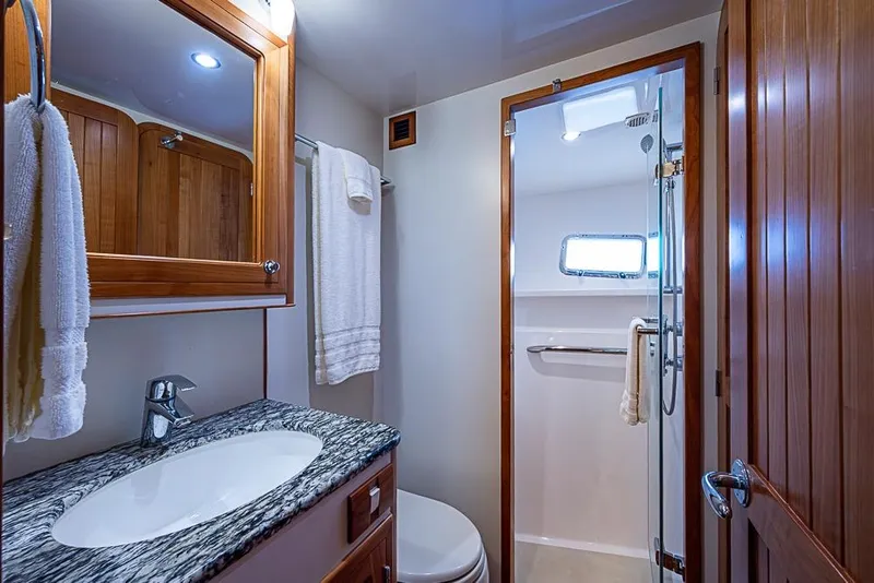 Slide: The Image of Luxurious bathroom in 2016 Kadey-Krogen 52 yacht with granite countertop and wooden accents. - 37