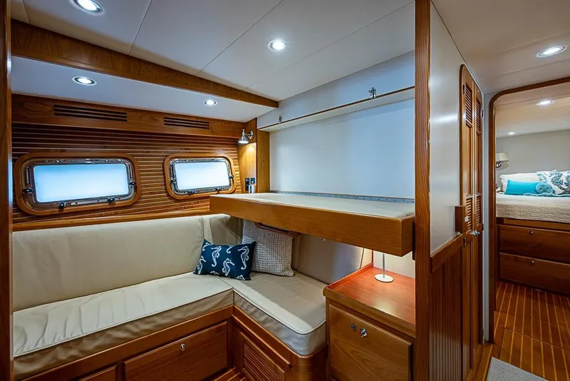 Slide: The Image of Luxurious 2016 Kadey-Krogen 52 yacht interior with wood paneling and cozy seating area. - 42
