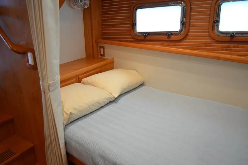 Slide: The Image of Cozy cabin interior of 2016 Kadey-Krogen 52 yacht with wooden accents and porthole windows. - 43