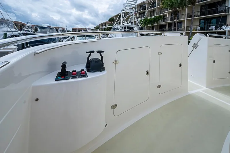 Slide: The Image of 2016 Kadey-Krogen 52 yacht deck with control panel and storage compartments. - 54