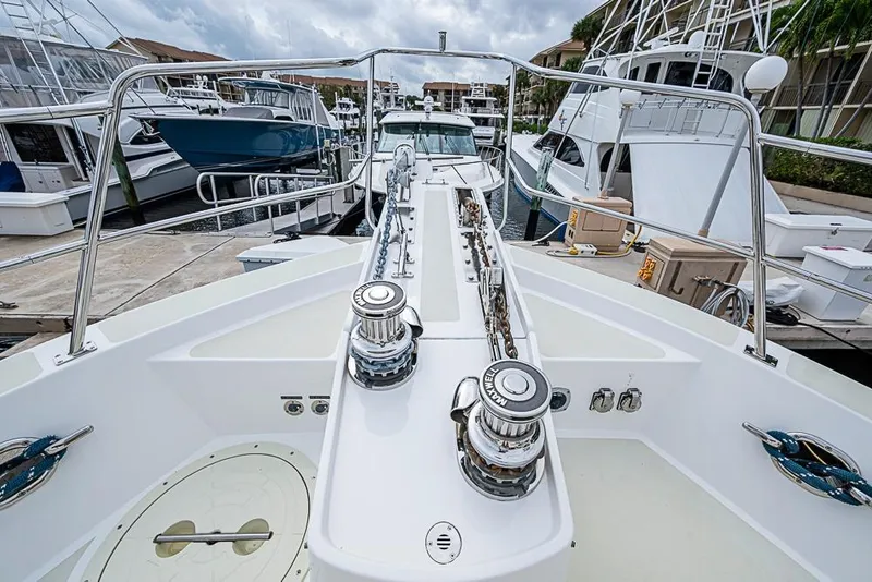 Slide: The Image of 2016 Kadey-Krogen 52 yacht docked, showcasing deck and winch details. - 56