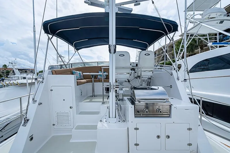 Slide: The Image of 2016 Kadey-Krogen 52 yacht deck with seating, grill, and helm under canopy. - 58