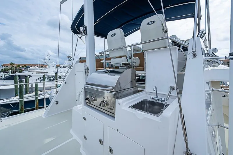 Slide: The Image of Outdoor kitchen on 2016 Kadey-Krogen 52 yacht with grill and sink, docked at marina. - 59