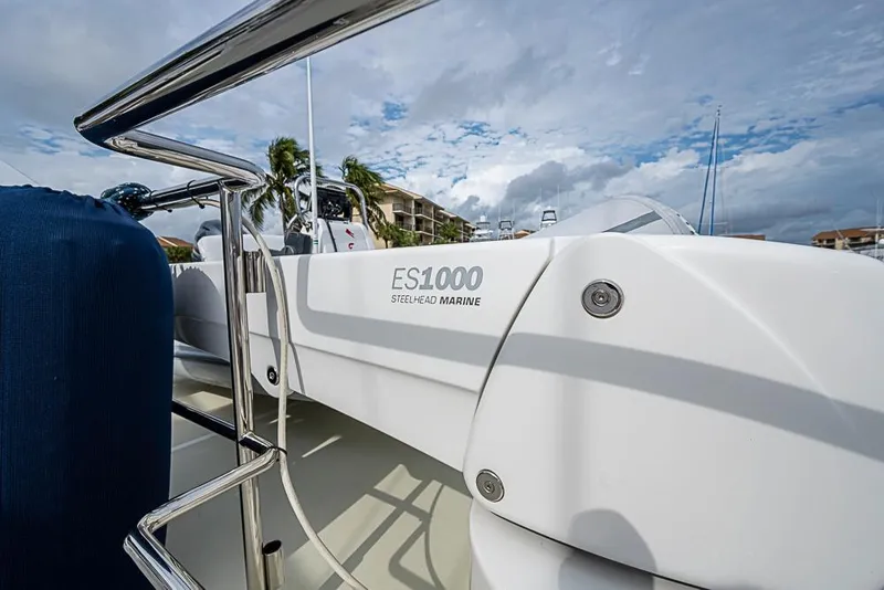 Slide: The Image of 2016 Kadey-Krogen 52 yacht with Steelhead Marine ES1000 crane, docked under cloudy skies. - 62