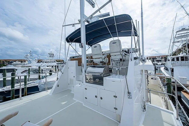 Slide: The Image of 2016 Kadey-Krogen 52 yacht deck with seating and grill, docked at marina. - 64