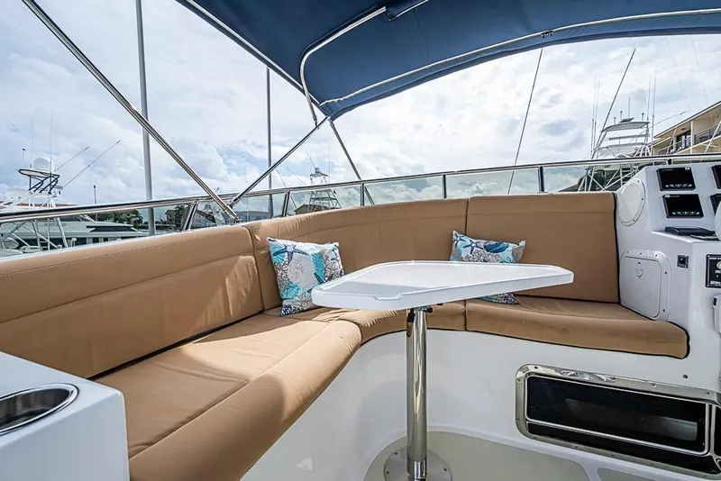 Slide: The Image of Luxurious seating area on 2016 Kadey-Krogen 52 yacht with blue canopy and cushions. - 65