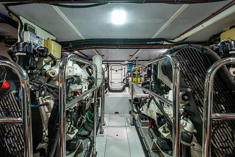 Slide: The Image of Engine room of 2016 Kadey-Krogen 52 yacht, featuring dual engines and polished metal railings. - 73