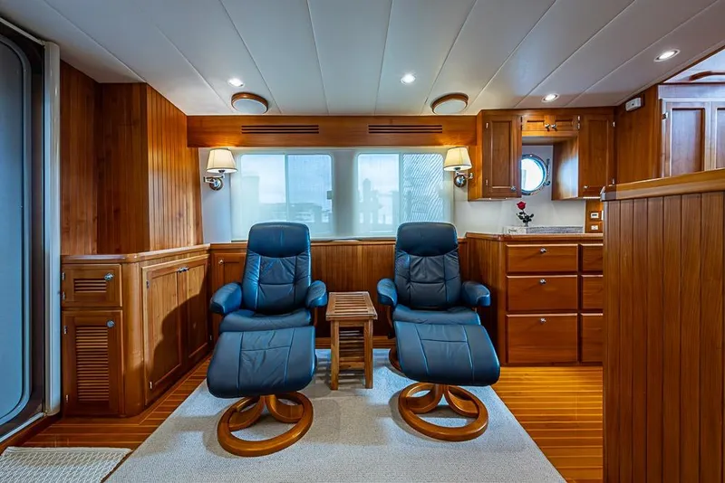 Slide: The Image of Luxurious interior of 2016 Kadey-Krogen 52 yacht with wooden cabinetry and blue recliners. - 8